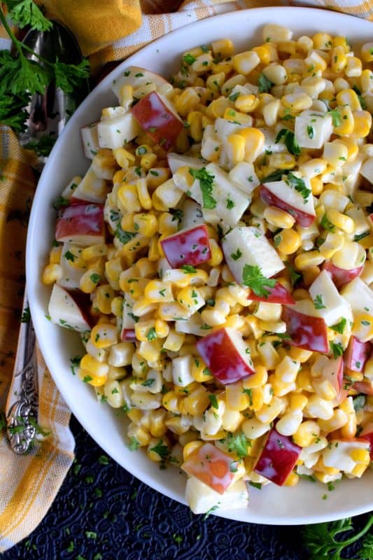With just a few ingredients, Apple and Corn Salad is one of those great tasting recipes that gives you lots of bang for your buck! This was oftentimes served with potato salads and chicken for Sunday night supper! #corn #apple #salad #summersalad #cornsalad #applesalad