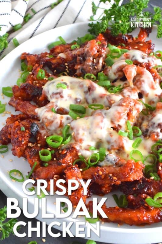 This crispy chicken is a Korean-inspired dish that is hot and spicy! Boneless and skinless thigh meat is dredged in cornstarch and fried until golden brown. Tossed in a vibrantly red and fiery sauce, Crispy Buldak Chicken is super flavourful and most certainly meant for the brave! #buldak #meltedcheese #korean #spicy #chicken #gochujang #gochugaru