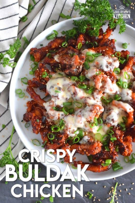 This crispy chicken is a Korean-inspired dish that is hot and spicy! Boneless and skinless thigh meat is dredged in cornstarch and fried until golden brown. Tossed in a vibrantly red and fiery sauce, Crispy Buldak Chicken is super flavourful and most certainly meant for the brave! #buldak #meltedcheese #korean #spicy #chicken #gochujang #gochugaru