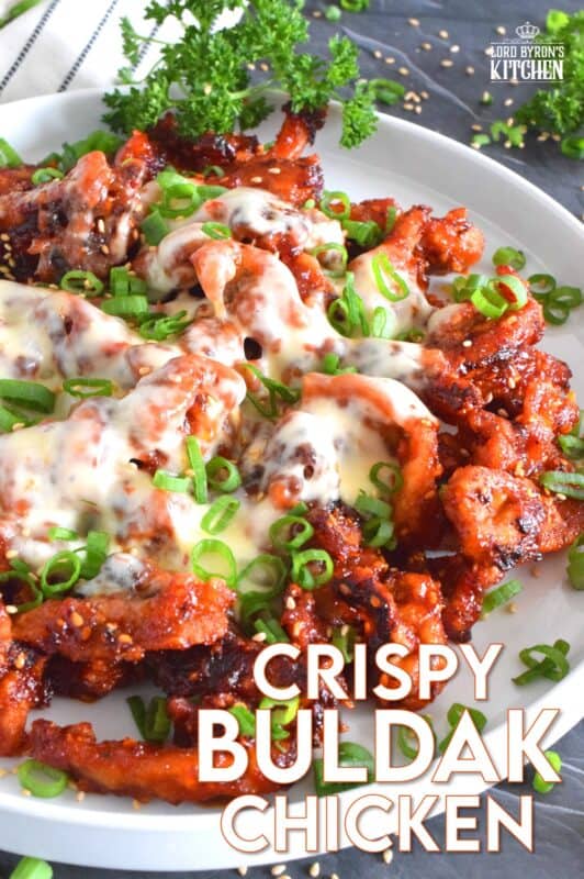 This crispy chicken is a Korean-inspired dish that is hot and spicy! Boneless and skinless thigh meat is dredged in cornstarch and fried until golden brown. Tossed in a vibrantly red and fiery sauce, Crispy Buldak Chicken is super flavourful and most certainly meant for the brave! #buldak #meltedcheese #korean #spicy #chicken #gochujang #gochugaru