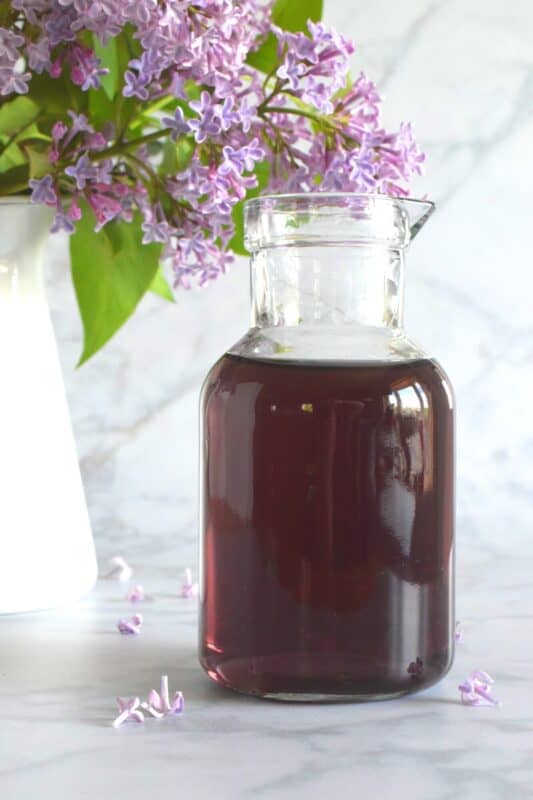 Lilacs are in full bloom right now, and if you're lucky enough to have a few trees near your house, I'm sure you can smell that lovely fragrance. Did you know that lilac petals are edible? Lilac Syrup is made with fully-bloomed lilac petals and is a great way to infuse some of your favourite early summer recipes with the lovely scent and a slightly citrus-like taste. #lilac #simplesyrup #cookingwithlilacs #lilacs #edibleflowers