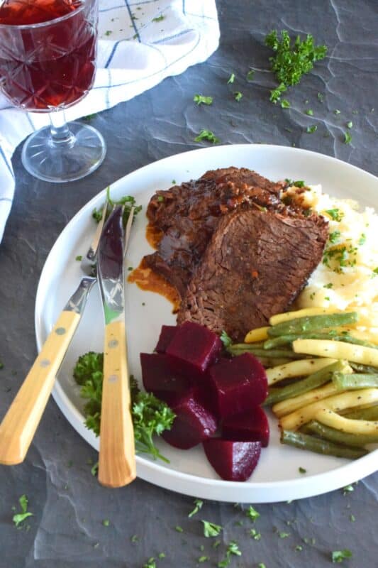 Succulent and moist, and slowly braised with onions and a delicious homemade broth consisting of brewed coffee, Beef Sirloin Tip Roast is delicious and a perfect meal for the entire family! Slow cooking and locking in moisture is the key to a tender, fall-apart roasted beef sirloin dinner! #sirloin #braised #beef #sunday #family #dinner