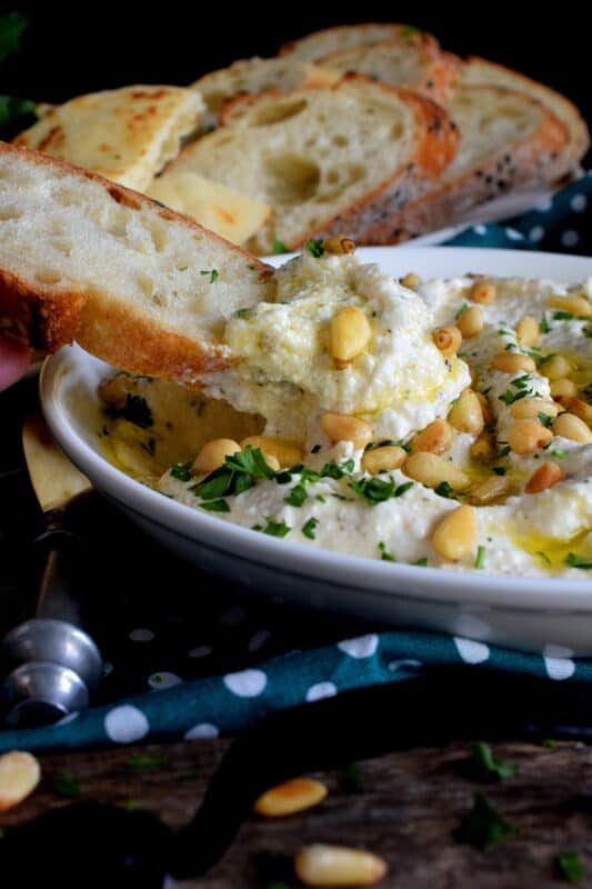 Salty and velvety smooth, seasoned with pantry herbs and spices, Creamy Whipped Feta will satisfy all of your snack cravings. Smear it on crackers and bread, or use it as a dip with veggies or pita. For even more flavour, be sure to toast the pine nuts first! #feta #fetadip #whippedfeta #dip #spread #appetizer