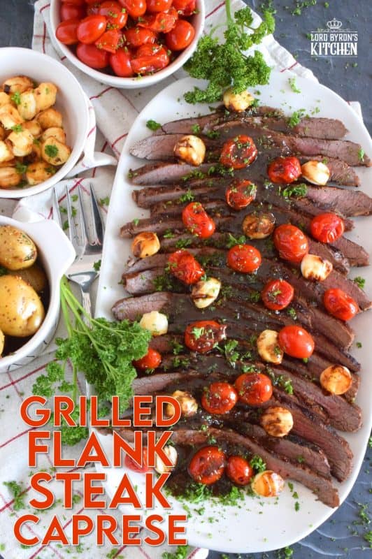 The key to a great tasting flank steak is the marinade. In this recipe, the steak is marinated in olive oil and balsamic vinegar, with mustard, honey, and garlic too. Grilled to your liking and served with blistered tomatoes and melted bocconcini, Grilled Flank Steak Caprese is a quick and easy, family-friendly meal! #flanksteak #beef #steak #grilling #caprese
