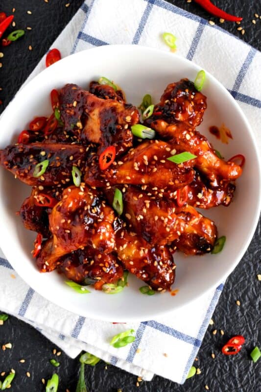 Perfectly baked chicken wings which have been tossed in a spicy sauce! Korean Gochujang Chicken Wings are completely addictive! These hit all of your taste buds with a little bit of spice, heat, sweet, and salt! #korean #gochujang #chicken #wings #spicy