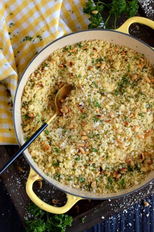 In less than 20 minutes, Parmesan and Pine Nut Couscous comes together to make the most delicious side dish. With the delicate crunch of the toasted nuts, and the salty nuttiness of the parmesan, this side tastes like high end restaurant dining, but prepared easily right in the comfort of your own kitchen! #pantry #ingredients #cooking #couscous #pinenuts #parmesan #cheese