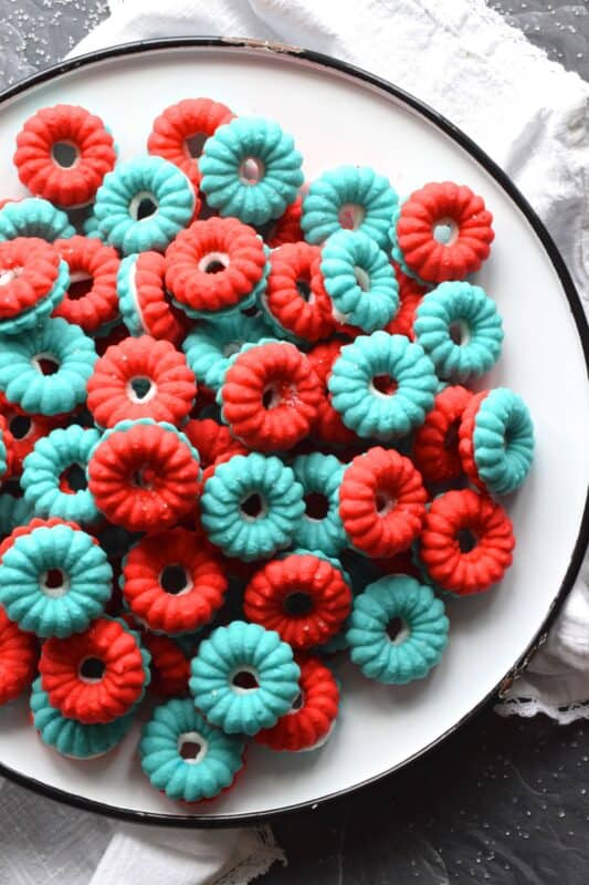 Everyone loves a spritz cookie, especially at Christmas! But, why should they only make an appearance once a year? In this version, I've coloured the cookie dough red and blue and sandwiched them with white frosting. These are most certainly bright and festive - perfect for your 4th of July celebrations! #spritz #cookies #sandwichcookies #redwhiteblue #4thofjuly #redwhiteandblue