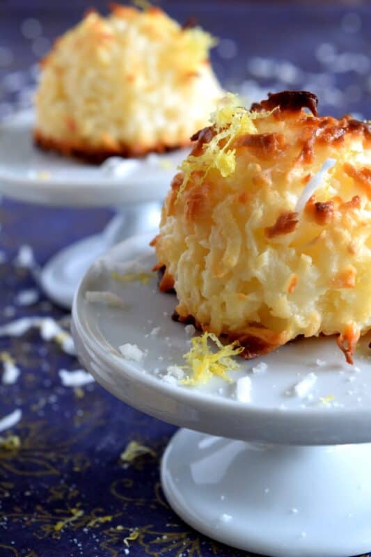 The popular Coconut Macaroon just got a whole lot better - with lemon!  Fresh lemon juice and zest gives this classic dessert a brand new taste and vibe; a perfect afternoon pick-me-up! This easy to make recipe comes together in less than 30 minutes so make them often! #macaroons #coconut #condensedmilk #lemon #zest 