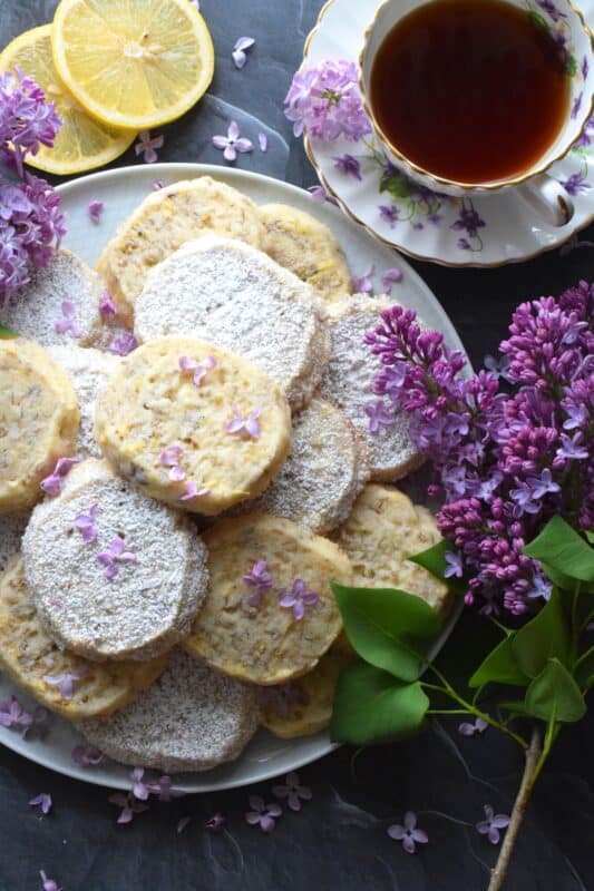 Prepare these cookies in advance and bake them up in a hurry whenever needed. Straight from the fridge to the oven, Lilac Lemon Cookies are delicious and pretty too! As an added bonus, these cookies can be rolled, wrapped, and frozen for up to three months! Then, when ready, thaw, slice, and bake! #lilac #lemon #cookies #edibleflowers #lilaccookies #lilacs