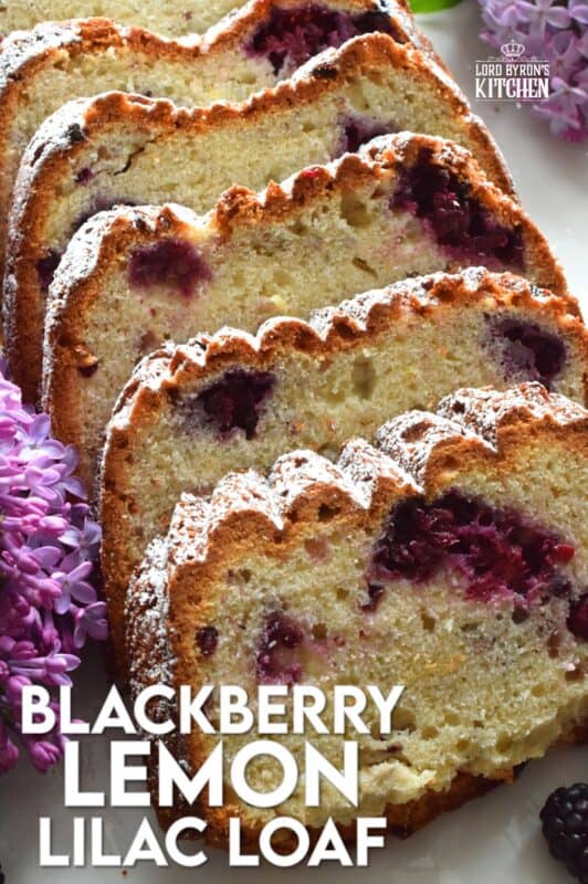 A super moist loaf prepared with fresh blackberries, lemon juice and zest, and hand-picked lilac petals. Not only is this Blackberry Lemon Lilac Loaf delicious and pretty, it is also quite fragrant! If you are fond of the smell of lilacs in early summer, this dessert is sure to please! #edibleflowers #lilacs #loaf #lemon #blackberry #lemonloaf #lilac