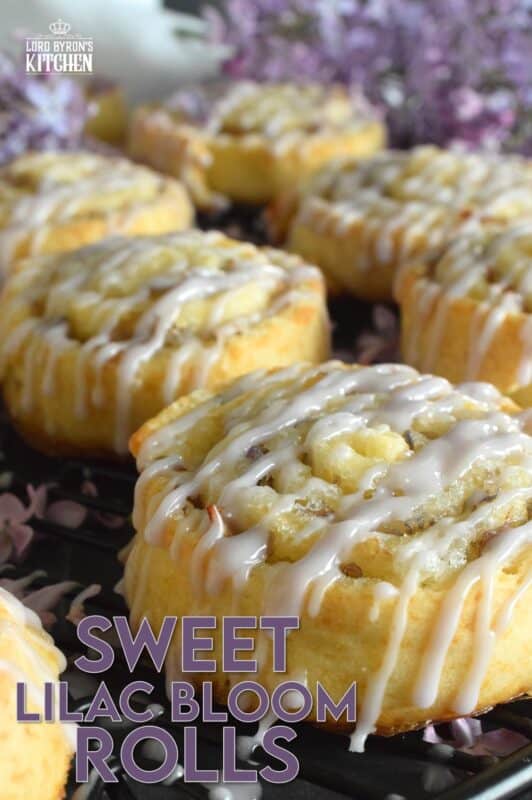 Sweet Lilac Bloom Rolls are made with a light, buttery, biscuit-like dough and rolled tightly with sugar and lilac petals. The sugar melts and begins to caramelize, while the petals infuse and permeate the rolls with a fresh fragrance and a mild lemony flavour. Drizzled with a lilac syrup icing, these are absolutely delicious and gorgeous too! #lilac #rolls #breakfast #brunch #frosting #iced #blooms #edibleflowers