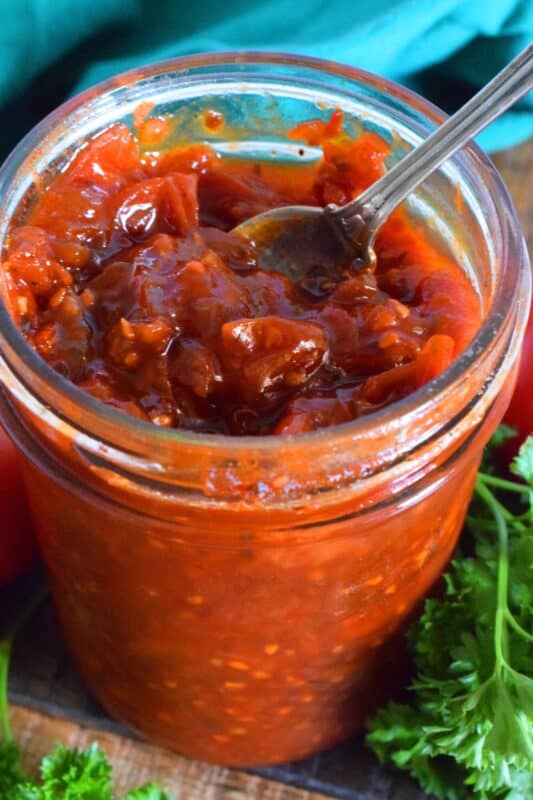 Sweet Tomato Jam is a thick, sticky jam prepared with summer fresh tomatoes, onions, and seasonings. Move over ketchup; there's a new condiment in town! #tomato #jam #sweet #homemade