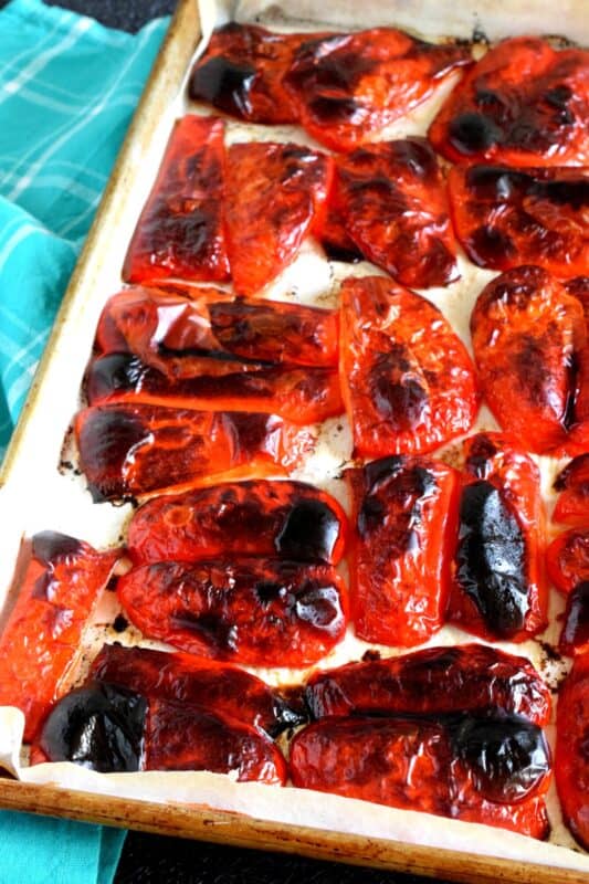 Roasted Red Peppers are a versatile condiment, ingredient, and topping. The ways to use Roasted Red Peppers and endless, and making your own is both easy and fun! If you don't grow your own, buy a bunch when there on sale and make your own roasted peppers at home! #redpeppers #roastedredpeppers #antipasto #canning #bellpeppers #preserving