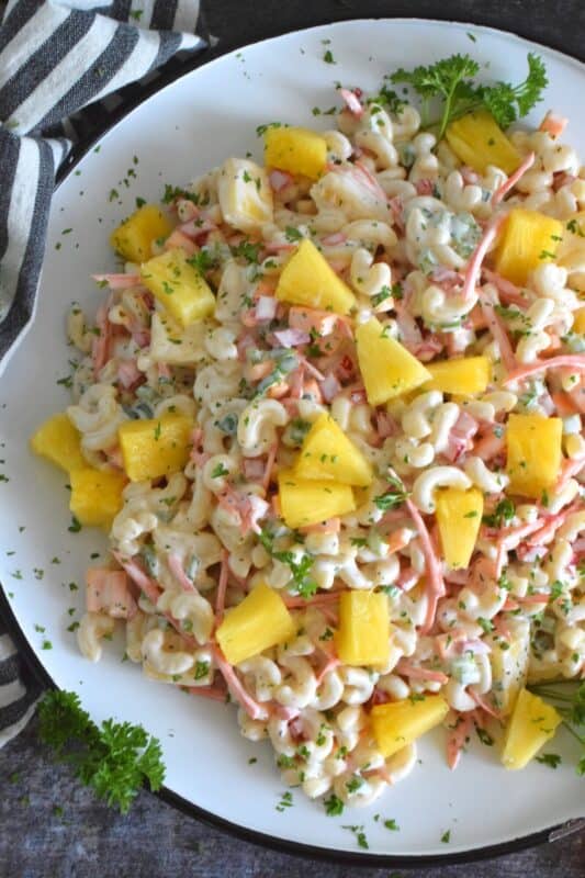A traditional Hawaiian Pasta Salad does not include fresh pineapple, however, the combination of the two is just wonderful! Loaded with lots of fresh veggies, and prepared with a lightened up creamy sauce, this version is delightfully refreshing and delicious too! #pasta #pastasalad #hawaiian #summersalad #picnic #bbq