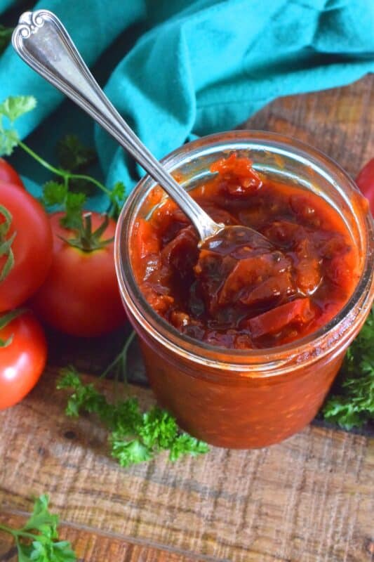Sweet Tomato Jam is a thick, sticky jam prepared with summer fresh tomatoes, onions, and seasonings. Move over ketchup; there's a new condiment in town! #tomato #jam #sweet #homemade