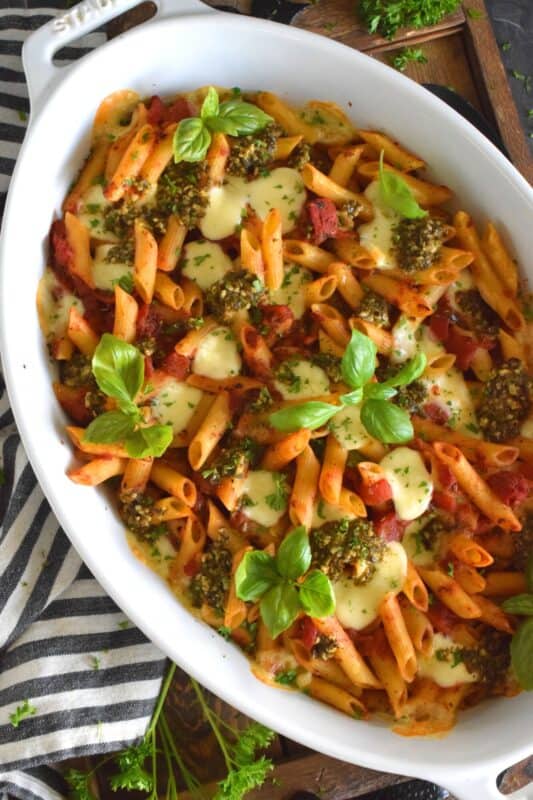 That title is a mouthful and that's exactly what you will have once you prepare this Garlic Butter Tomato and Pesto Baked Pasta in your home! Perfectly cooked pasta is flavoured with both seasoned tomatoes and basil pesto and baked with garlic butter and bocconcini until melted and gooey. This just might be my new favourite way to make pasta! #bakedpasta #pasta #casserole #ziti #basil #pesto #cheesy #garlicbutter