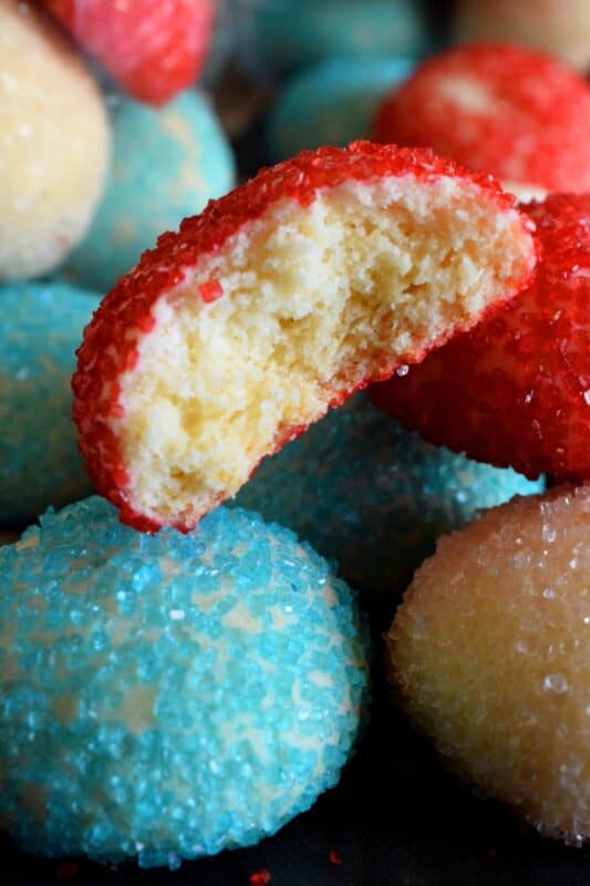 Just in time for your 4th of July celebration, these melt-in-your-mouth Red White and Blue Cookies are about to steal the spotlight with their sparkling beauty and their delicious taste! With just 5 ingredients, these cookies are not only easy to make, they're pretty to look at too! #redwhiteandblue #4thofjuly #independenceday #cookies #treats #sprinkles