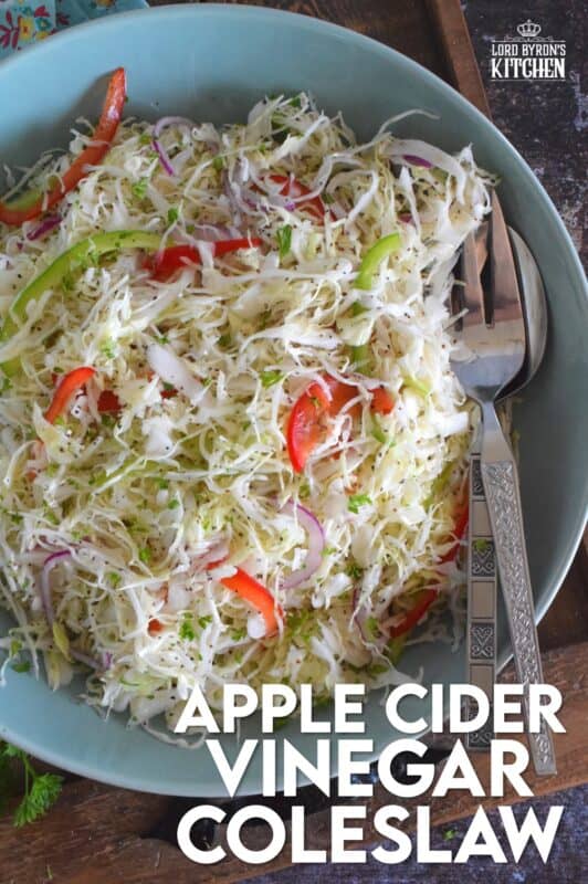Apple Cider Vinegar Coleslaw is packed with robust flavours!  Like most coleslaw recipes, this one starts with shredded cabbage, but it is combined with red and green bell peppers, and thinly sliced red onions too.  Tossed in a sweet oil and vinegar dressing, it’s hard to say no to a second helping! #coleslaw #vinegary #applecider #salad #summersides