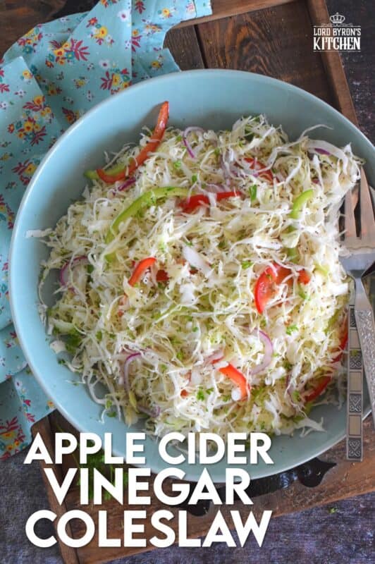 Apple Cider Vinegar Coleslaw is packed with robust flavours!  Like most coleslaw recipes, this one starts with shredded cabbage, but it is combined with red and green bell peppers, and thinly sliced red onions too.  Tossed in a sweet oil and vinegar dressing, it’s hard to say no to a second helping! #coleslaw #vinegary #applecider #salad #summersides
