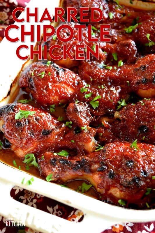 In this Charred Chipotle Chicken recipe, inexpensive drumsticks are baked with onion and then topped with a thick, sweet sauce consisting of chipotle peppers in adobo sauce, vinegar, brown sugar, and more. This is certainly an easily family pleasing main! #bakedchicken #drumsticks #spicychicken #chipotle #adobosauce #saucy