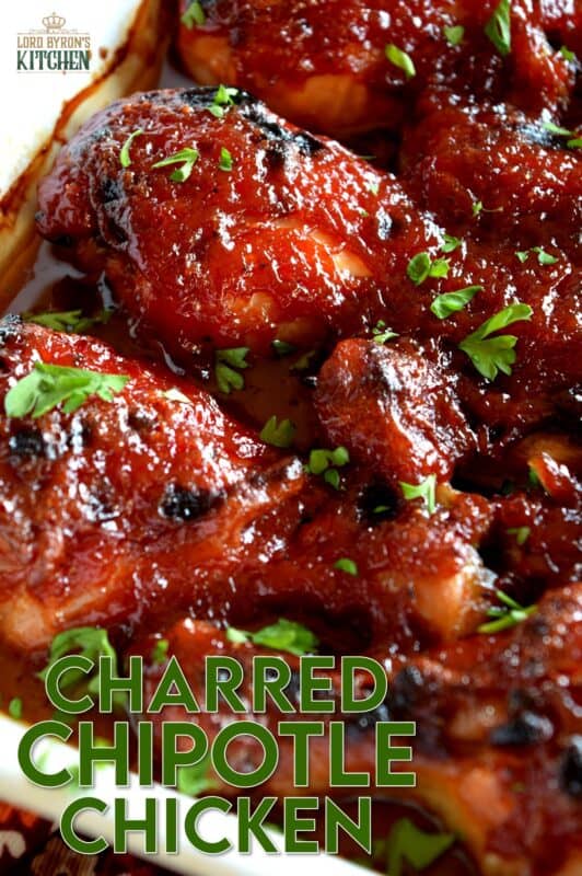 In this Charred Chipotle Chicken recipe, inexpensive drumsticks are baked with onion and then topped with a thick, sweet sauce consisting of chipotle peppers in adobo sauce, vinegar, brown sugar, and more. This is certainly an easily family pleasing main! #bakedchicken #drumsticks #spicychicken #chipotle #adobosauce #saucy