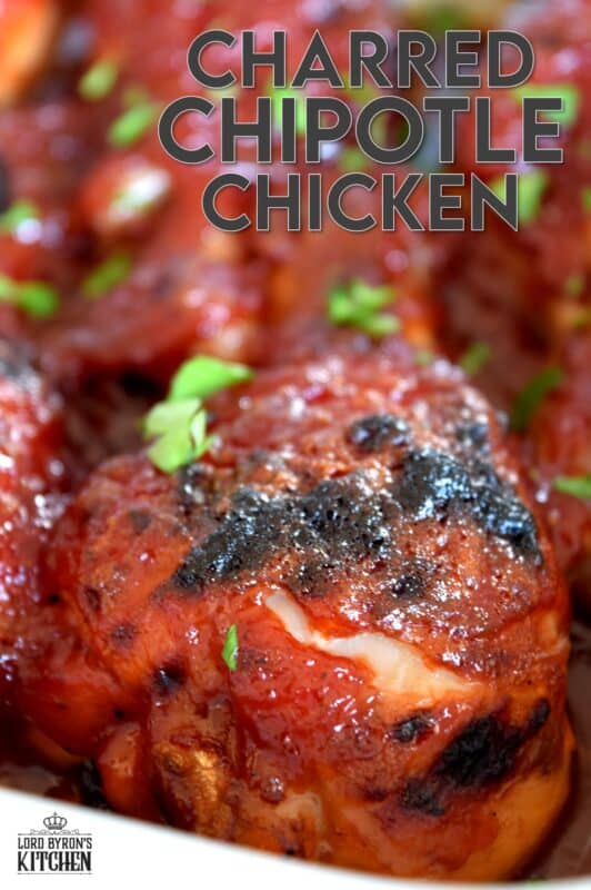 In this Charred Chipotle Chicken recipe, inexpensive drumsticks are baked with onion and then topped with a thick, sweet sauce consisting of chipotle peppers in adobo sauce, vinegar, brown sugar, and more. This is certainly an easily family pleasing main! #bakedchicken #drumsticks #spicychicken #chipotle #adobosauce #saucy