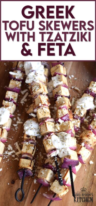 Extra firm tofu is marinated with red onion in a mixture of olive oil and the best quick and easy homemade Greek seasoning.  Grilled until slightly charred and topped with tzatziki and crumbled feta, these skewers are a great grilled meat alternative! #grilledtofu #tofu #greekrecipes #vegetarian #summergrilling