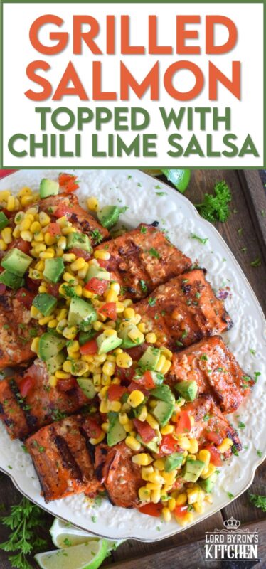 Salmon fillets are marinated in olive oil with honey, lime juice, seasonings, and spices then grilled until charred, yet still light and flaky on the inside. Topped with a salsa consisting of avocado, corn, tomatoes, and lime, this grilled salmon is not only refreshing and delicious, but also quite a beautiful and impressive main for you and your family this summer! #salmon #grillesalmon #chililime #salsa #summermeals #grilled #seafood