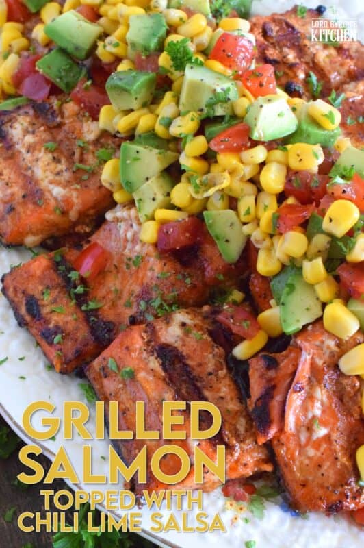 Salmon fillets are marinated in olive oil with honey, lime juice, seasonings, and spices then grilled until charred, yet still light and flaky on the inside. Topped with a salsa consisting of avocado, corn, tomatoes, and lime, this grilled salmon is not only refreshing and delicious, but also quite a beautiful and impressive main for you and your family this summer! #salmon #grillesalmon #chililime #salsa #summermeals #grilled #seafood