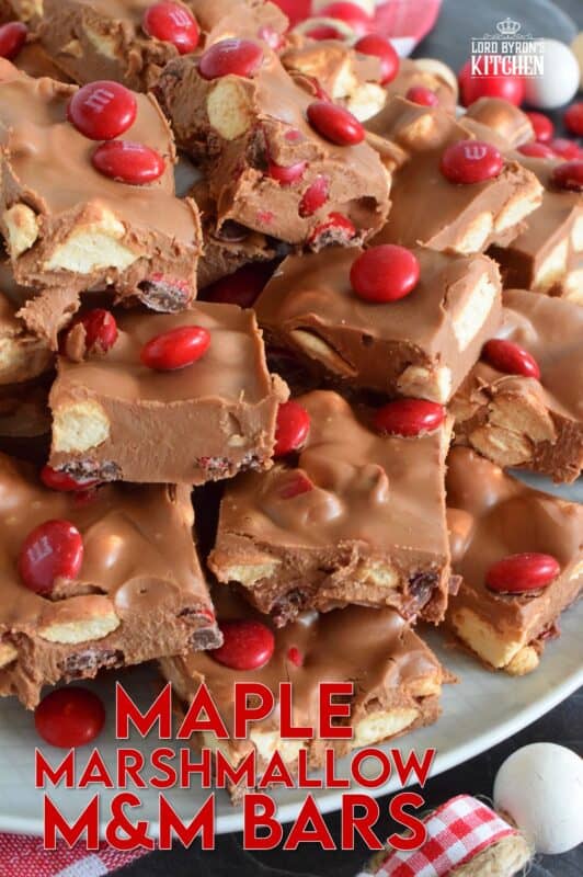 Prepared with chocolate, maple flavoured marshmallows, candy, and more, Maple Marshmallow M&M Bars are a cross between homemade fudge and a store-bought candy bar. Whip up a batch and keep them in your freezer. They are super delicious when eaten frozen on a cold, summer day! #marshmallow #maple #nobake #canadaday #fudge #redandwhite #candy