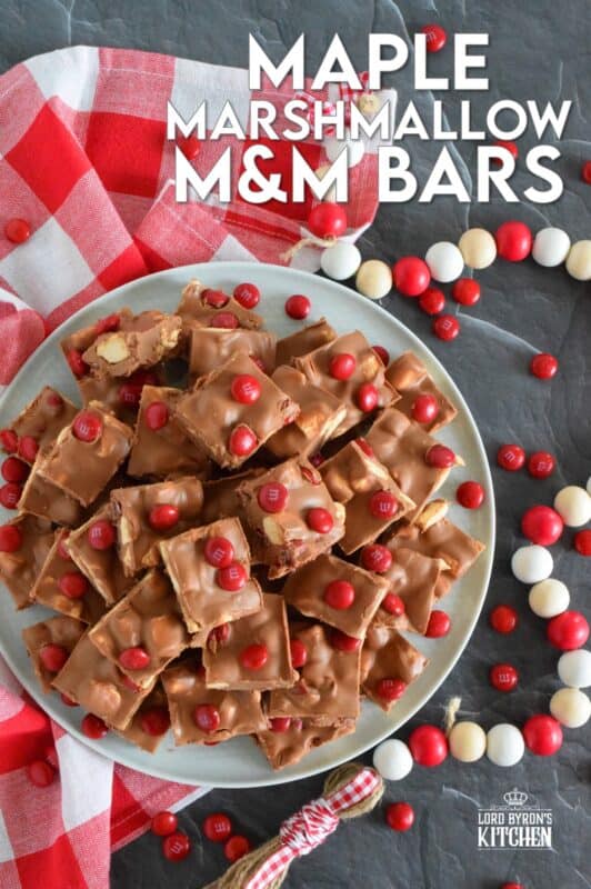 Prepared with chocolate, maple flavoured marshmallows, candy, and more, Maple Marshmallow M&M Bars are a cross between homemade fudge and a store-bought candy bar. Whip up a batch and keep them in your freezer. They are super delicious when eaten frozen on a cold, summer day! #marshmallow #maple #nobake #canadaday #fudge #redandwhite #candy