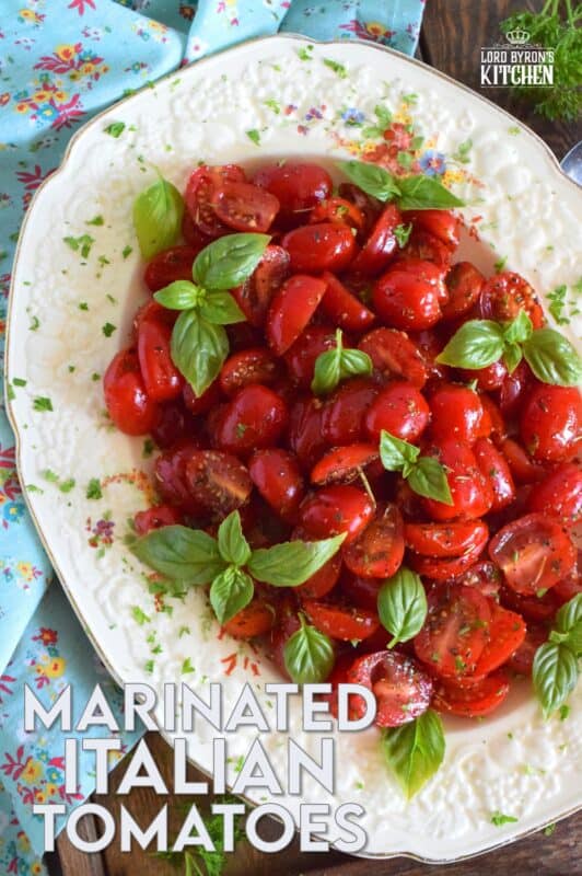 Cherry tomatoes are halved and marinated in a sweet and savoury blend of olive oil, vinegar, honey, and Italian seasoning. Topped with fresh basil leaves, these Marinated Italian Tomatoes make a delicious side dish, salad, or a topping for grilled baguette. #tomatoes #summerfresh #locallygrown #sides #marinated #salad #italian