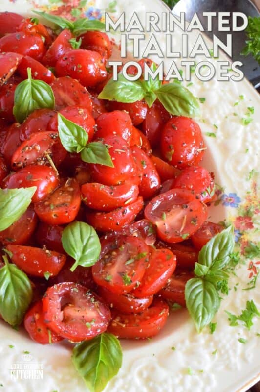 Cherry tomatoes are halved and marinated in a sweet and savoury blend of olive oil, vinegar, honey, and Italian seasoning. Topped with fresh basil leaves, these Marinated Italian Tomatoes make a delicious side dish, salad, or a topping for grilled baguette. #tomatoes #summerfresh #locallygrown #sides #marinated #salad #italian