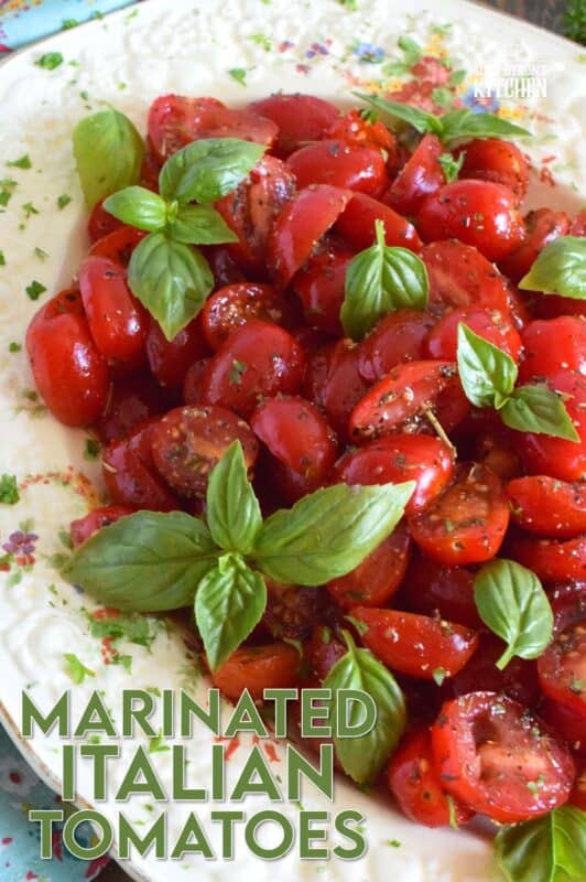Cherry tomatoes are halved and marinated in a sweet and savoury blend of olive oil, vinegar, honey, and Italian seasoning. Topped with fresh basil leaves, these Marinated Italian Tomatoes make a delicious side dish, salad, or a topping for grilled baguette. #tomatoes #summerfresh #locallygrown #sides #marinated #salad #italian