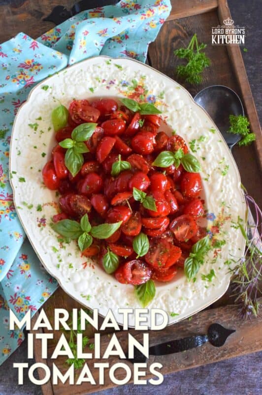 Cherry tomatoes are halved and marinated in a sweet and savoury blend of olive oil, vinegar, honey, and Italian seasoning. Topped with fresh basil leaves, these Marinated Italian Tomatoes make a delicious side dish, salad, or a topping for grilled baguette. #tomatoes #summerfresh #locallygrown #sides #marinated #salad #italian