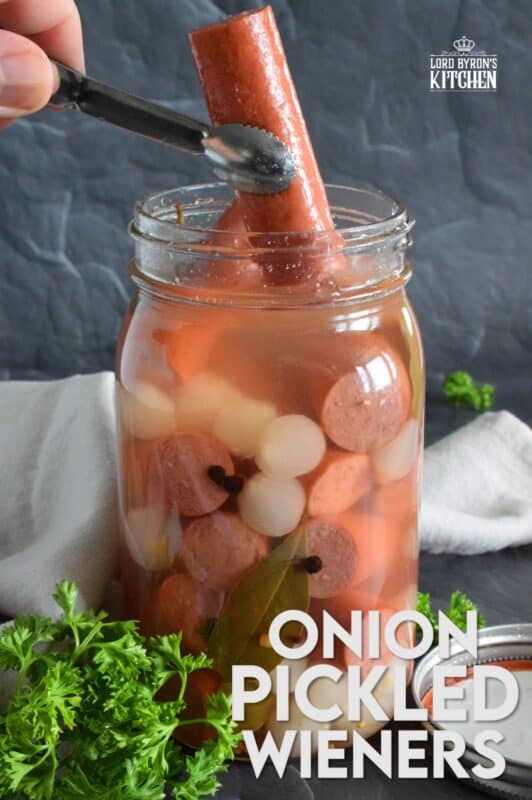 The easy to do recipe combines the flavour of the classic highway gas station pickled wieners with the bright, tart and sweet flavour of jarred pickled onions. Keep a jar in your fridge at all times for a quick snack or an easy lunch served with cheese and crackers! #pickled #wieners #cocktail #onions #pickledwieners