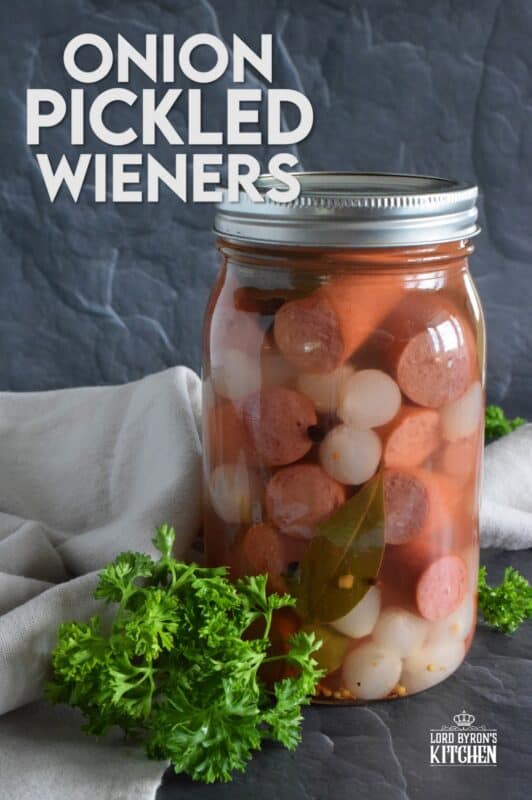 The easy to do recipe combines the flavour of the classic highway gas station pickled wieners with the bright, tart and sweet flavour of jarred pickled onions. Keep a jar in your fridge at all times for a quick snack or an easy lunch served with cheese and crackers! #pickled #wieners #cocktail #onions #pickledwieners