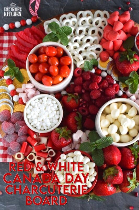 Gather together a bunch of red and white snack foods to assemble this super easy Canada Day Charcuterie Board! Your friends and family will love filling up on these festive snacks. Set the board down right into the middle of your patio table, and let everyone help themselves! All you need is a bunch of napkins and lots of ice cold drinks! Happy Canada Day! #canadaday #canada #charcuterie #redandwhite #festive #snacks