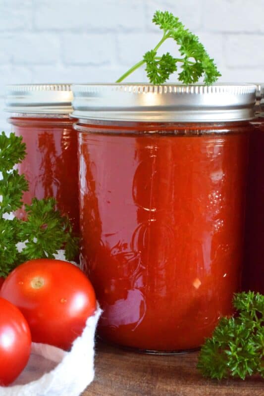 The number of recipes that have tomato sauce as an ingredient are far too plentiful to count! Store bought canned tomato sauce fails in comparison to a homemade version. Working with summer fresh, locally grown tomatoes, this recipe will help to contain all of that freshness and flavour which will elevate your favourite recipes all winter long! #tomatoes #tomatosauce #preserving #canning #foodstorage