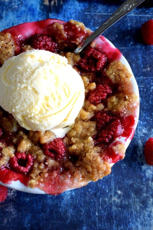 Made from simple ingredients, Rustic Raspberry Crumble is an impressive dessert with very little effort! For added pizzazz, prepare the mixture in individually portioned dessert ramekins; they're much more impressive that way! And, of course, no matter how delicious a crumble might be, it always needs a scoop of good vanilla ice cream! #crumble #rasberries #berries #summerfresh #easydesserts