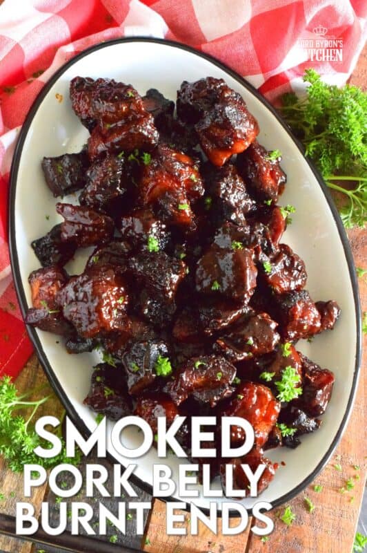 Barbecued Smoked Pork Belly Burnt Ends are prepared with trimmed and cubed pork belly which has been dry rubbed with a sweet spice blend. The pork is smoked with apple wood before being tossed with sauce and returned to the smoker to char up. #porkbelly #smoked #smoker #smokedrecipes #bbq #smokedpork #burntends