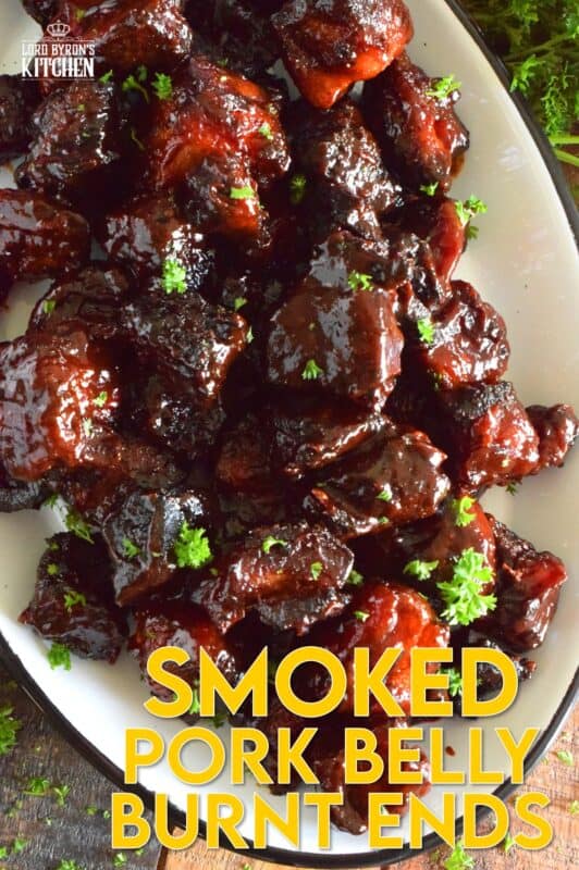 Barbecued Smoked Pork Belly Burnt Ends are prepared with trimmed and cubed pork belly which has been dry rubbed with a sweet spice blend. The pork is smoked with apple wood before being tossed with sauce and returned to the smoker to char up. #porkbelly #smoked #smoker #smokedrecipes #bbq #smokedpork #burntends