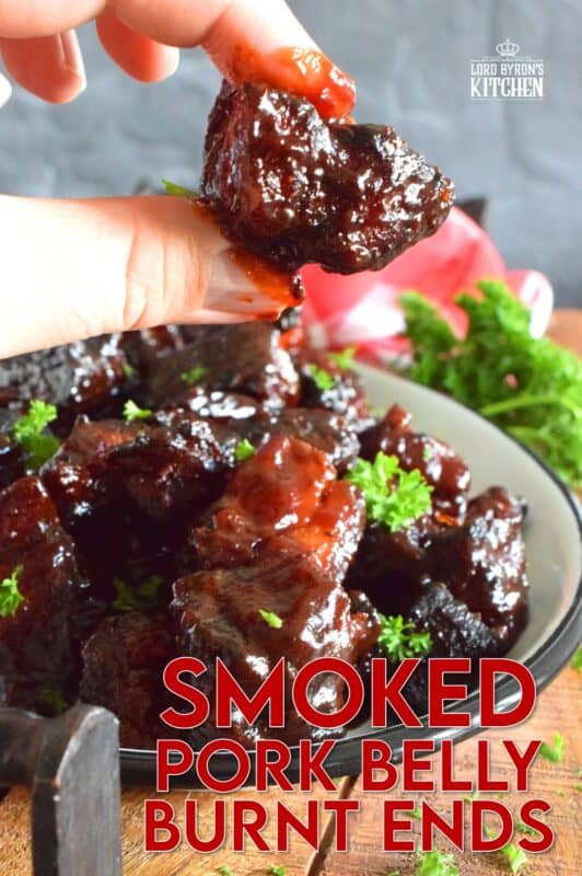 Barbecued Smoked Pork Belly Burnt Ends are prepared with trimmed and cubed pork belly which has been dry rubbed with a sweet spice blend. The pork is smoked with apple wood before being tossed with sauce and returned to the smoker to char up. #porkbelly #smoked #smoker #smokedrecipes #bbq #smokedpork #burntends