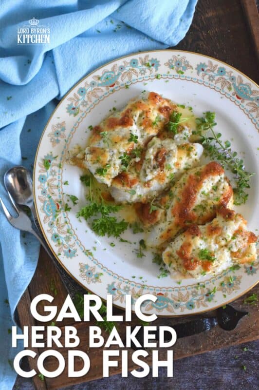 Fresh cod fillets are generously topped with fresh minced garlic and a variety of chopped fresh herbs which is combined with mayonnaise and grated parmesan cheese. The fish is perfectly baked until brown and bubbly. Garlic Herb Baked Cod Fish is both savoury and delicious! #cod #fish #seafood #bakedcod #parmesancod #freshherbs