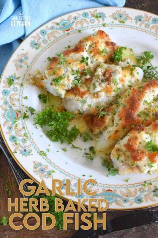 Fresh cod fillets are generously topped with fresh minced garlic and a variety of chopped fresh herbs which is combined with mayonnaise and grated parmesan cheese. The fish is perfectly baked until brown and bubbly. Garlic Herb Baked Cod Fish is both savoury and delicious! #cod #fish #seafood #bakedcod #parmesancod #freshherbs