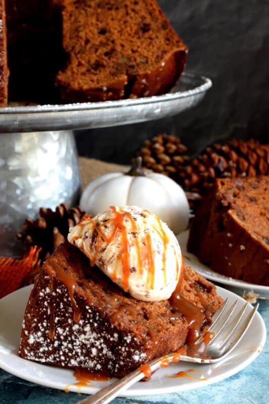 Perfectly moist and decadent on its own, but can be dressed to impress with a scoop of ice cream and some caramel drizzle. Pumpkin Spice Walnut Chocolate Bundt cake is a big cake and it's perfect for sharing! #pumpkinspice #pumpkin #spice #walnut #chocolate #bundt #cake #bundtbakers