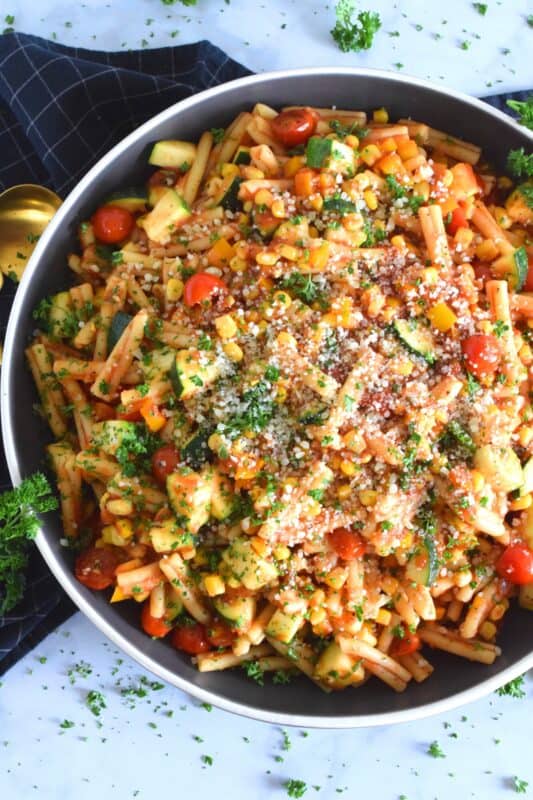 Prepared with fresh tomatoes, corn, and zucchini, Summer Salsa Pasta comes together in less than 25 minutes. With a bright, fresh, flavour, this pasta dish relies heavily on some of the best that summer has to offer. Top with parmesan cheese and grab a fork; dinner is ready! #salsa #summersalsa #pasta #summerpasta #zucchini #corn #tomatoes #meatless