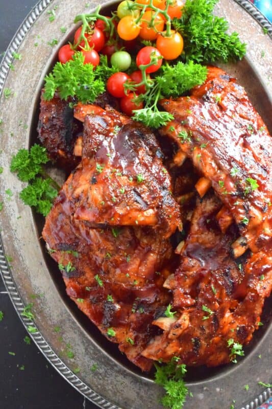 Super moist and tender pork ribs are first prepared in an instant pot and then brushed with a homemade chipotle tequila barbecue sauce. The ribs are then tossed on the grill until that delicious sauce becomes hot, sticky, and stuck to those gorgeous ribs by means of beautiful grill marks. Are you drooling yet? #chipotle #tequila #bbq #ribs #porkribs #pork