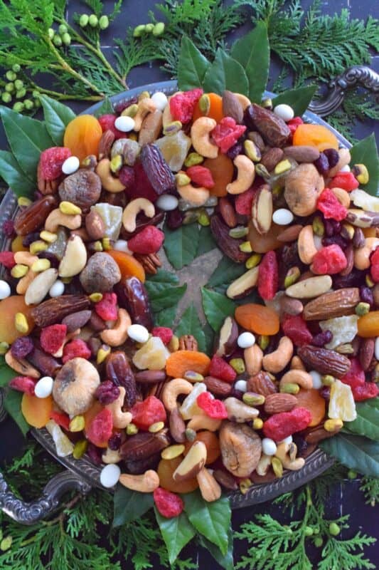 Christmastime is synonymous with nuts and fruits, so with that in mind, a Nuts and Dried Fruit Wreath was an obvious choice! No cooking or baking is necessary here! Assemble this beautiful, healthy snack wreath in very little time with a quick trip to your favourite bulk food supply store! #driedfruit #nuts #snacks #christmas #partyfoods #snackbowl