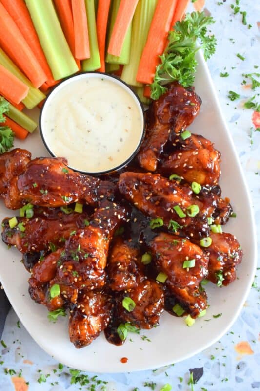 In this recipe, chicken wings are baked until golden brown and crispy and then they're tossed in a hot and spicy homemade sauce which is prepared in just a few minutes. Sweet Red Devil Wings are perfectly cooked and drenched in a thick, sticky sauce that I just can't get enough of! #sweetandsticky #wings #chicken #sauce